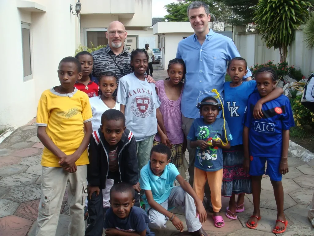Dr. Papadopoulos with children during a volunteer medical mission
